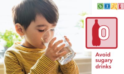 Young child drinking a glass of water
