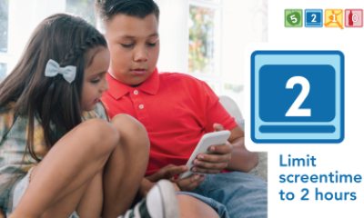 Two children look at the screen of a mobile phone