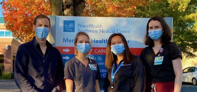 PGY2 residents pose in front of the Southwest Medical Center entrance sign with program leader Carolyn Wong.