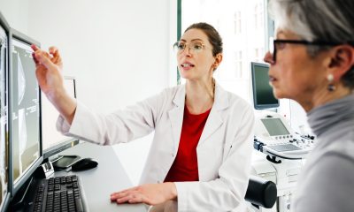 breast surgeon explains mammogram image to patient