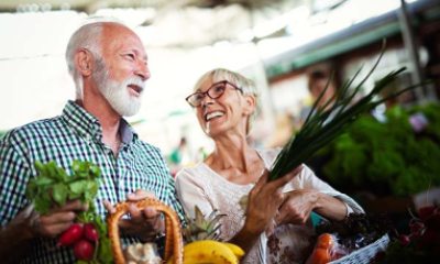 man and woman shop for fresh produce