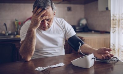 Man taking his blood pressure with an at home test.