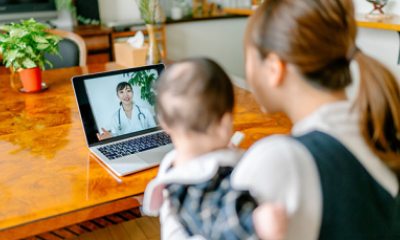 young mother with baby talk with a doctor via laptop
