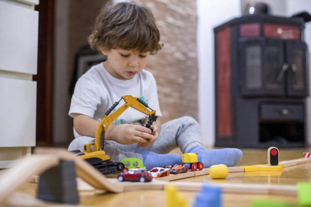 Toddler playing with his toys.