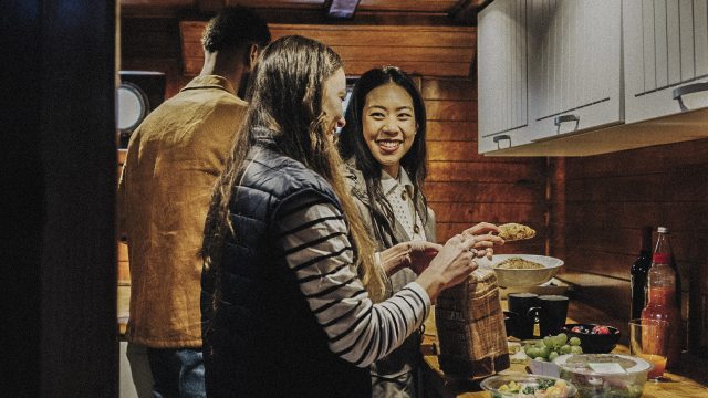Young people prepare food in a cozy kitchen