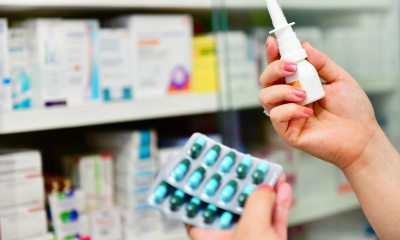 Close-up of hands holding medications at pharmacy