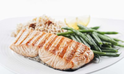 Fillet of fish, green beans and wild rice on a white plate