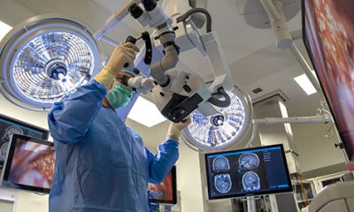 Surgeon operating a kinevo microscope