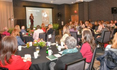 Women of Peace sponsor, Sarah Ness speaks to attendees from the stage