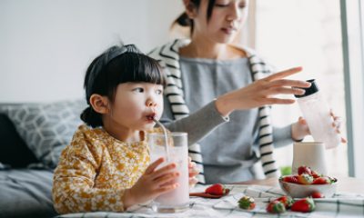 Young girl drinks using a straw