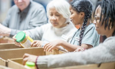 Volunteers pack boxes of supplies at a food bank