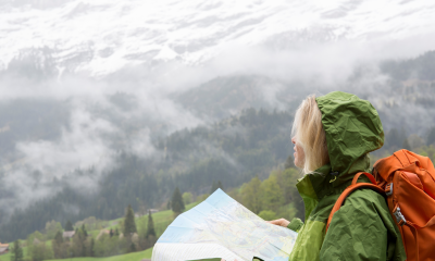A hiker surveying the landscape while browsing a map